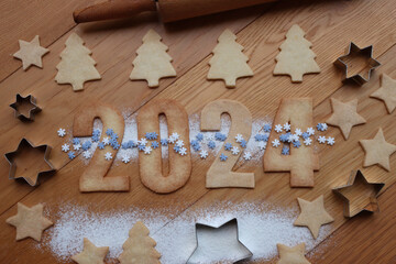 Shortcrust cookies with blue and white snowflake  sprinkles in the form of numbers 2024 with cookie...