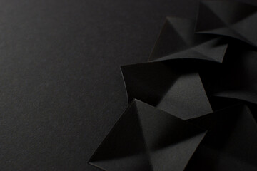 Black abstract background with black geometric shapes, copy space