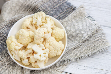 Cauliflower vegetables standing on a white wooden table