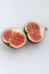Fig fruits cut on a plate, juicy ripe flesh with seeds