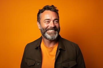 Obraz premium Medium shot portrait photography of a pleased man in his 30s against a light orange background