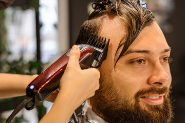 Machine cutting. Step 2 training in men's haircuts. Start at the back of the head using the smaller...