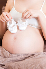 close up of a person holding a baby shoes