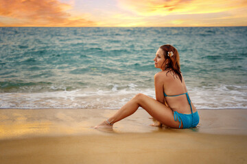 A beautiful girl in a bikini on a wild beach, bathing in the clear waves of the warm sea. a heavenly place and a beautiful model.