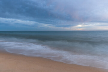 Fototapeta na wymiar Sunset at sandy beach on Altantic Ocean coast in Portugal