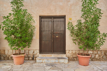 Brown wooden door at the entrance to arab house in old Dubai