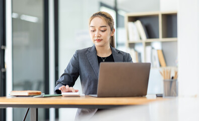 Business asian woman working at office with documents on his desk, doing planning analyzing the financial report, business plan investment, finance analysis concept