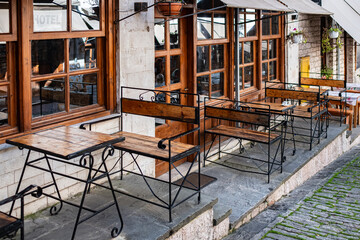 Wooden table. Outdoor cafe with wooden tables. Natural tables near a street cafe on a sunny summer day
