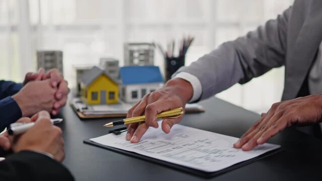 Business people selling, buying or mortgage and signing agreement paperwork for loan financial to buying apartment house properties.