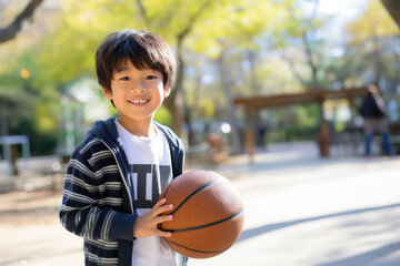 smiling chinese boy with basketball on the street, kids fun without gadgets, vacation, technology independence - obrazy, fototapety, plakaty