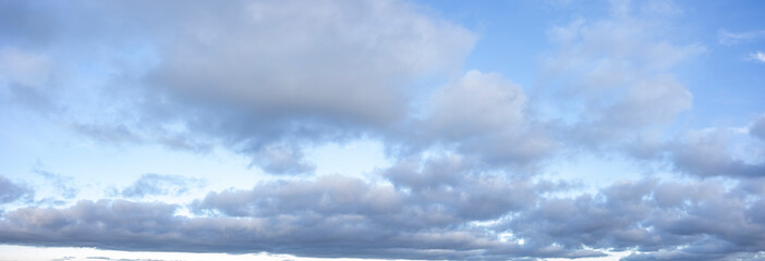 Panoramic cloudscape with blue sky and soft white clouds