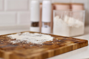 flour on a wooden board in a modern light kitchen