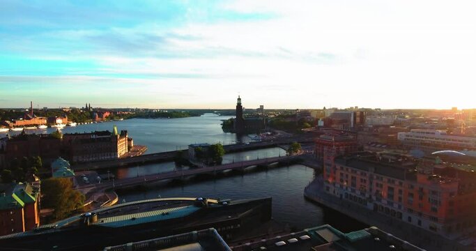 Aerial Backward Shot Of River Amidst Buildings In City Against Sky - Stockholm, Sweden