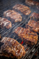 Steaks are in various stages of cooking