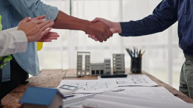 Close up of hands working brainstorming and measuring for cost estimating on paperworks and floor plan drawings about design architectural and engineering for houses and buildings.