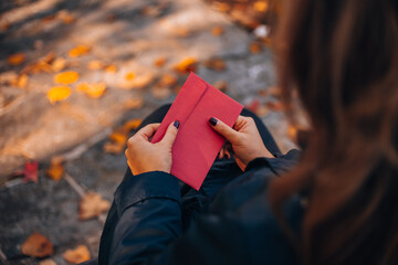 Beautiful red envelope in hand close up. Mockup card invitation greeting card postcard copy space...