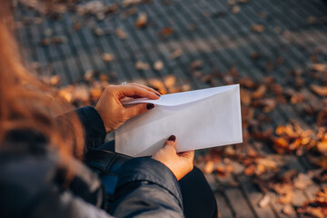 White blank envelope in a woman's hand