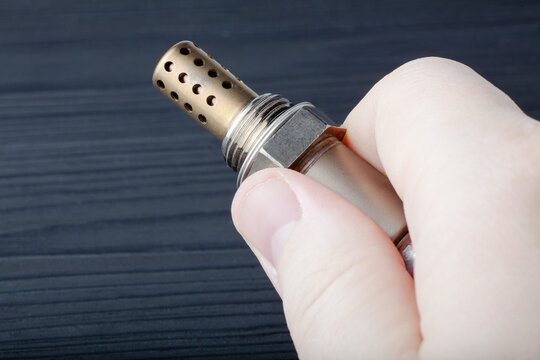 Oxygen sensor for gasoline and diesel engines in the hand. lambda probe is reliable component to optimize your car's performance