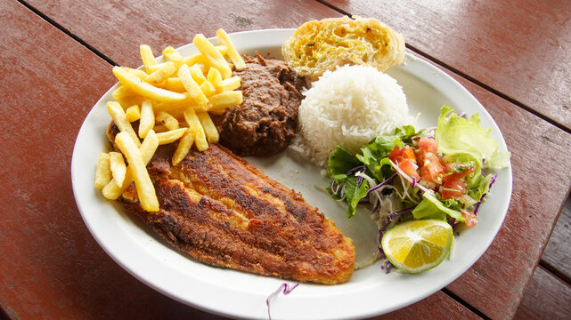 Costa Rican Grilled Fish Casado With Salad, Rice, Bread and French Fries 