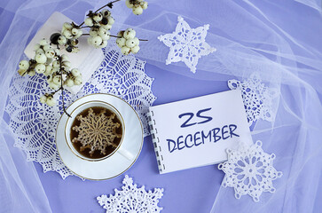 Calendar for December 25: a cup of tea with a decorative snowflake on a lace napkin, the name of...