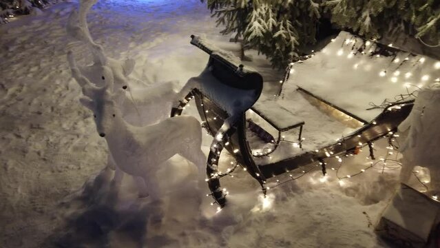 Worn-out Christmas reindeers with sledge decoration