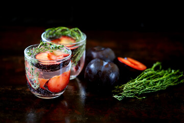 Detox drink with mineral water, plums and thyme.