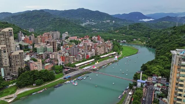 Aerial 4k footage of Bitan in Taipei, Taiwan. It is a popular spot to relax and ride boats along the river.
