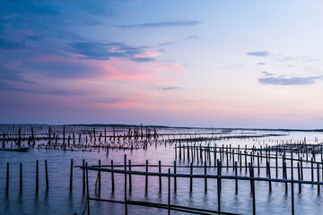Sunset view of the Z-shaped Oyster sheds in front of Guanhai House in the Qigu Lagoon of Tainan, Taiwan. 