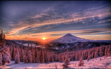 A HDR shot of a sunrise, with a pink and purple sky. The sun is peeking behind a snow-capped mountain, creating a halo effect