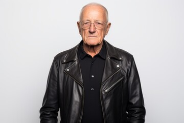 Fototapeta premium Portrait of a glad man in his 70s sporting a stylish leather blazer against a white background. AI Generation