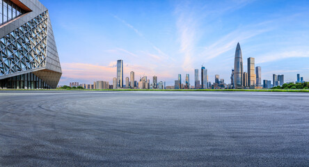 Asphalt road square and urban skyline with modern buildings at sunset in Shenzhen, Guangdong Province, China.