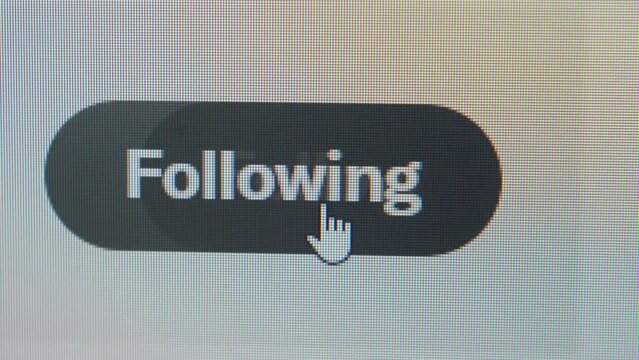 User clicking following button to unfollow an acount on social media