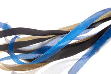 Colorful ribbon long straight fly in air with curve roll shiny. Blue silver gold black ribbon for present gift birthday party to wrap around decorate, blow fly in wind. White background isolated