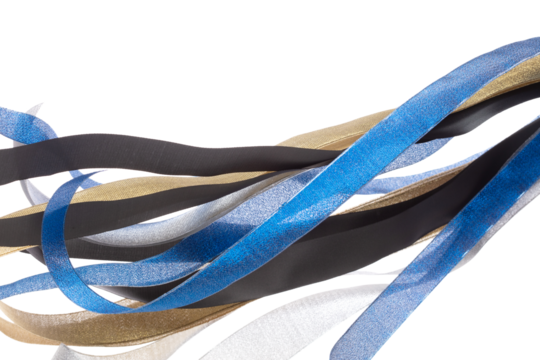Colorful ribbon long straight fly in air with curve roll shiny. Blue silver gold black ribbon for present gift birthday party to wrap around decorate, blow fly in wind. White background isolated