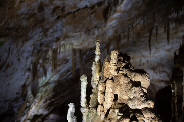 The cave is karst, amazing view of stalactites and stalagnites illuminated by bright light, a beautiful natural attraction in a tourist place.