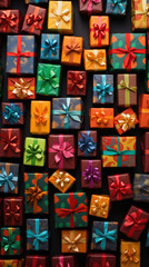 Colorful gift boxes with ribbons on black background. Top view.