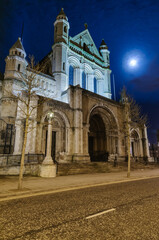 Fototapeta na wymiar St Anne's Cathedral, Belfast, at night with a full moon behind