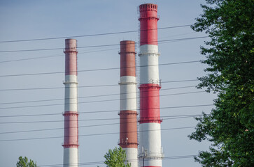 Chimneys of a power plant against a blue sky