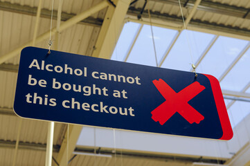 Sign advising customers that alcohol cannot be purchased at this checkout under Northern Ireland Licencing laws