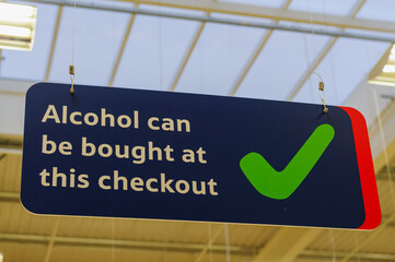 Sign advising customers that alcohol can be purchased at this checkout under Northern Ireland...
