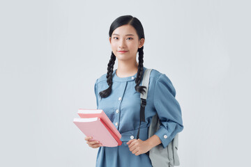 Female student with backpack isolated on white background