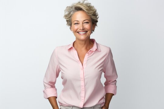 Portrait Of Happy Caucasian Eldery Short-hair Woman In An Elegant Pink Clothes Smiling And Standing On White Backround. Shopping And Style