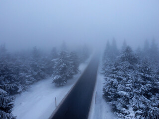 snow covered road in winter with fog