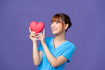 Attractive woman with heart, isolated on purple background