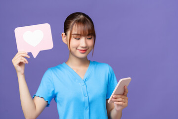 Young woman hold mobile cell phone heart form like icon sign from social network media feedback