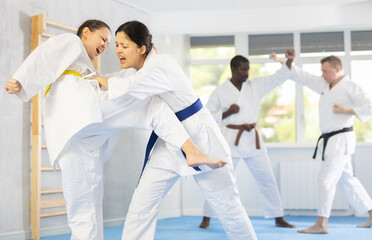 Karate with two female athletes practicing, training and sparring in fight class. Healthy, fit and...