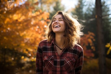 Portrait of a joyful woman in her 20s dressed in a relaxed flannel shirt against a background of autumn leaves. AI Generation