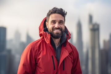 Portrait of a merry man in his 30s wearing a windproof softshell against a stunning skyscraper skyline. AI Generation