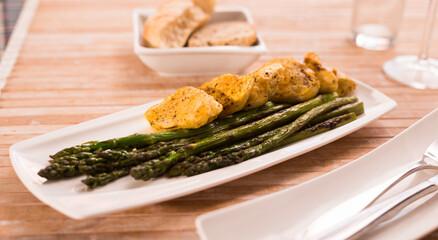 Dietary meal rich in protein. Stir fried chicken breast and green asparagus