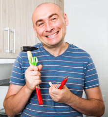 Ordinary man posing with hammer in his hands